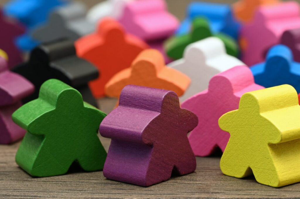 multi-colored meeples on a table