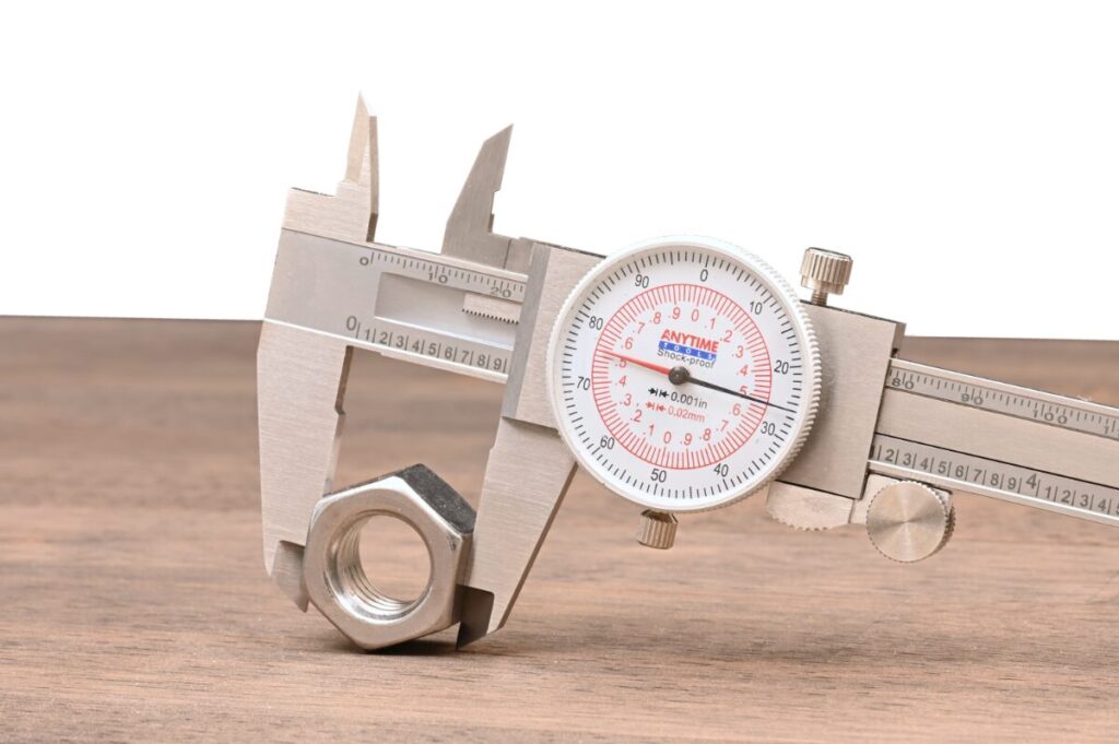 micrometers measuring a stainless nut